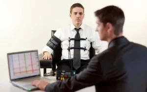 A polygraph test examinee dressed in white is being tested.
