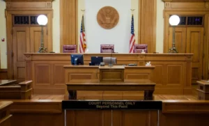 A U.S. courtroom with American flags.