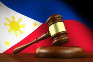 A gavel and the Philippine flag in the background.