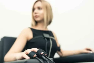 Side image of a young female polygraph examinee dressed in black.