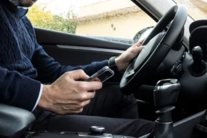 a man using his phone while driving a vehicle