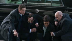 Bodyguards protecting client under attack (Gerard Butler)