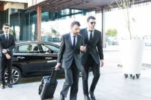 Two private bodyguards accompany the client.