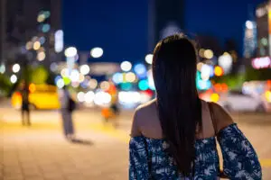Woman look at the city of Taipei city at night